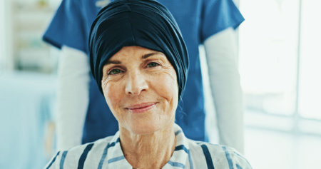 Woman, portrait and nurse with wheelchair for cancer treatment, smile and recovery at hospital....