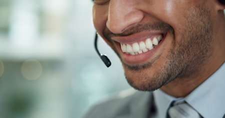Person, call center and mouth with microphone, headset and customer service with smile in modern office. Man, consultant or agent with contact us, happy and voip connection for support at help deskの写真素材
