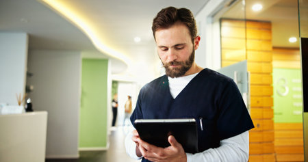 Clinic, dentist and man with tablet for medical service, appointment schedule and research....