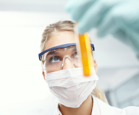 Woman, liquid vial and scientist for thinking in clinic, lab technician and urine test for drugs. Female person, biology research and monitor fluid for disease or infection, check protein and examの写真素材