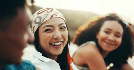 Friends, laughing and relax on beach outdoor of travel reunion, summer vacation and talk for funny joke. Smile, people and women with discussion for holiday getaway, social gathering and weekend tripの写真素材