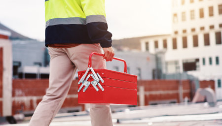 Man, hands and technician walking with toolbox on rooftop in city for ac machine repair labor. Maintenance, engineering or contractor on building fixing hcav for installation or safety inspectionの写真素材
