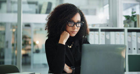 Research, thinking and woman in office with laptop, ideas or budget review at accounting agency. Consultant, accountant or businesswoman with financial administration, online report or business planの写真素材