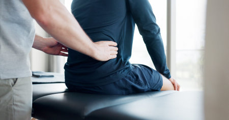 Back pain, physiotherapy and consulting with people in clinic for deep tissue pressure, tension and...