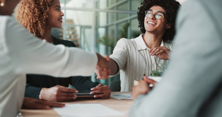 People, happy and handshake in office for agreement, creative collaboration and new partnership. Design team, meeting and shaking hands in agency for deal, support and project onboarding in companyの写真素材