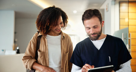 Patient, dentist and tablet for results in clinic, check medical records and appointment schedule. People, oral specialist and online for orthodontics info, lobby consult and help for hygiene serviceの写真素材