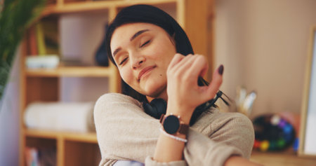Woman, relax or stretching with arm for break, rest or unwind in comfort at home office. Calm, female person or consultant agent with headset for remote work, recovery or tension relief at houseの写真素材