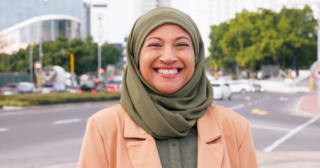 Islamic woman, happy and portrait in city for travel, fashion and religious pride in Saudi Arabia. Mature person, Muslim and outdoor in Abu Dhabi with hijab, confidence or face with smile for holidayの写真素材