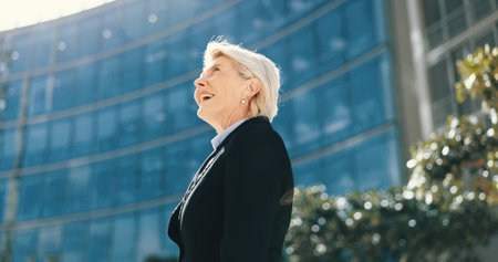 Happy, business woman and thinking in city for insight, professional mindset or laugh. Smile, planning and mature manager outdoor with idea, vision and inspiration for urban development opportunityの写真素材