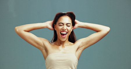 Excited, hair care and woman with beauty in studio, growth and texture for color on background. Hairstyle, makeup and model in cosmetics for hairdresser treatment, aesthetic and laughing at salonの写真素材