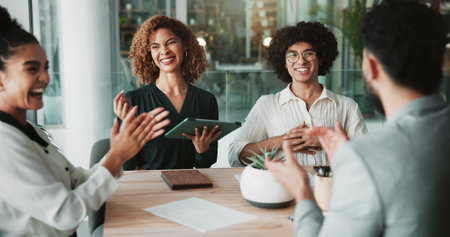 Business people, applause and meeting with team, startup or celebration with success for agreement in office. Men, women and tablet with announcement, achievement or happy for deal at creative agencyの写真素材