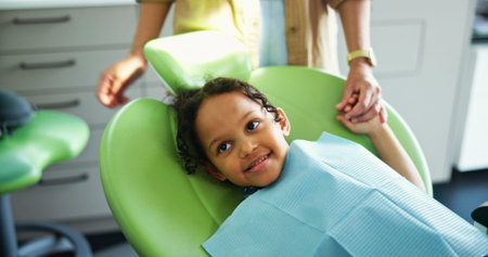 Dentist, consulting and child on chair with parent for toothache, gum disease and wellness....