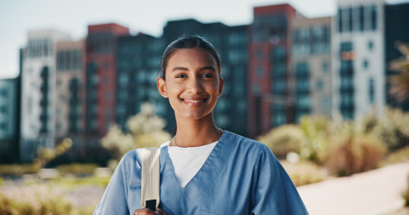 Nurse portrait, healthcare and woman outdoor for health training program, medicine study or hospital residency. Medical school, student and happy with backpack on campus for education and career pathの写真素材