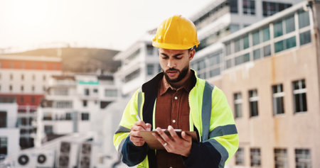 Writing, engineer and clipboard with man in city for architecture, building or inspection. Construction site, contractor and project manager with person in outdoor for urban development updateの写真素材