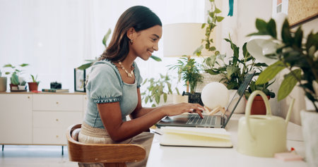 Typing, research and laptop with woman in home office for social media, communication and blog post. Freelancer, online and networking with person or remote worker for ebook, writer and connectionの写真素材