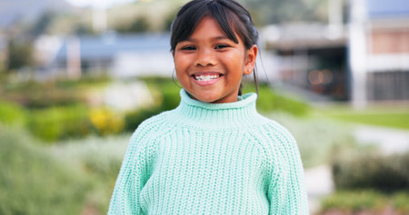 Portrait, smile and sustainability with Indian child outdoor in garden for eco friendly fashion. Conservation, development or growth and happy girl in nature with going green mindset for planet earthの写真素材