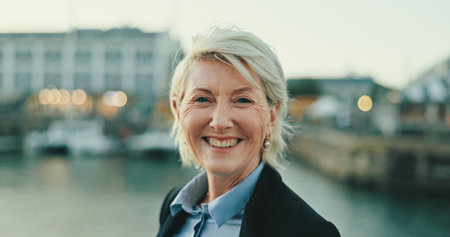 Smile, mature and portrait of business woman in city for lawyer, corporate and legal counsel. Professional, confidence and attorney with person in Berlin outdoors for commute, pride and advocateの写真素材