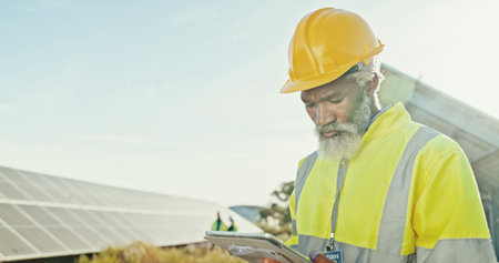 Solar panel, sustainability and black man with tablet, engineering and internet with problem solving. Inspector, typing and person with tech, quality control and network with app for online scheduleの写真素材