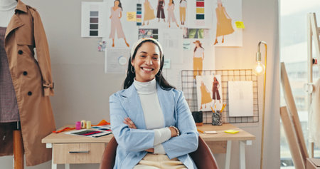 Arms crossed, creative and portrait of fashion designer woman in textile workshop for production. Clothes, confident and wall with happy style director at desk in office for manufacturing processの写真素材