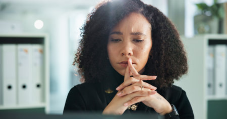 Woman, lawyer and thinking with stress by computer, confused and glitch at night in modern office. Person, attorney and reading with problem solving, research and investigation for case at law firmの写真素材