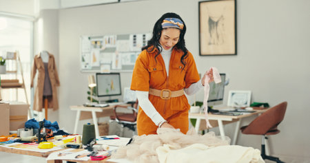 Choice, creative and fabric with fashion designer woman in textile workshop for textile decision. Clothing industry, material and process with style director in office for manufacturing or productionの写真素材