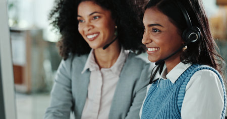 Call centre, training and manager with headset, happy and smile for help, telemarketing and trainee. Colleagues, office and internship for people, consultation and advice for customer serviceの写真素材