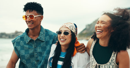 Friends, beach and group laugh with sunglasses, hug and fashion for holiday, adventure or summer vacation. Happy, man and women with shades, ocean and travel bonding for weekend trip to Miami journeyの写真素材