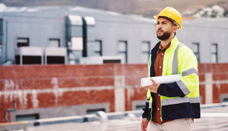 Businessman, architect and helmet with blueprint for construction or industrial development in city. Man, civil engineer or contractor with project for building inspection, safety or maintenanceの写真素材