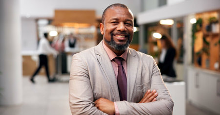 Portrait, hotel and black man with arms crossed, smile and professional with hospitality. African person, accommodation and manager with confidence, pride and lodge with service, lobby and contact usの写真素材