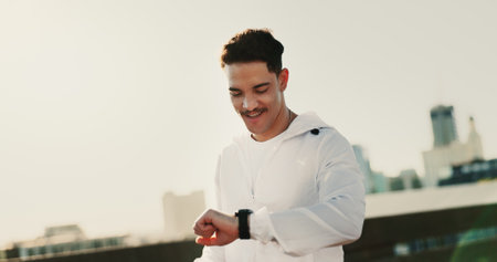 Man, runner and smart watch for fitness in city with smile for training, challenge or timer with mockup space. Person, athlete and check stopwatch in road for workout, progress or happy in Costa Ricaの写真素材