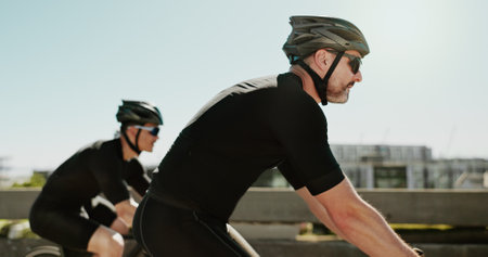 Fitness, race and cycling with people in city for triathlon challenge, training and workout. Wellness, exercise and competition with profile of men and bike in outdoors for sports, speed and cardioの写真素材