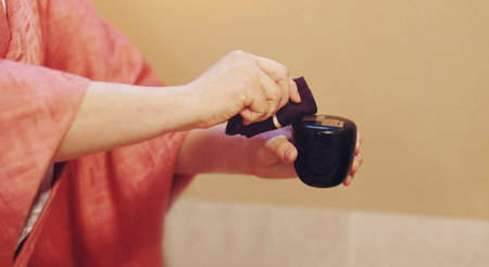 Japan, person or hands with cloth for tea ceremony, tradition or culture with scent, essence or aroma at home. Closeup, hostess and incense smell with fabric for traditional matcha, ritual or Chanoyuの写真素材