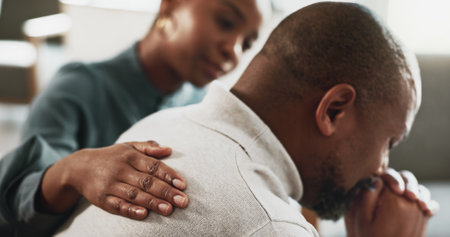 Sad, black man and emotion with therapist for empathy, therapy session or mental health at appointment. African, male person or patient with psychologist for counselling, support or consolidationの写真素材