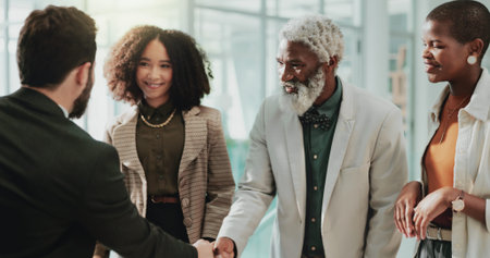 Business, men and handshake with staff in office for partnership, introduction and interview success. People, meeting and agreement for respect of promotion deal, onboarding offer and b2b opportunityの写真素材