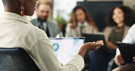 Laptop, hand and businesswoman in team meeting with graph, financial data and leader planning. Computer, group or manager brainstorming stats for risk management, kpi or discussion in office workshopの写真素材
