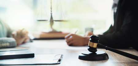 Meeting, lawyers and hands of business people with gavel for legal consultation, contract and discussion. Corporate office, professional and workers for legislation, agreement and deal at law firmの写真素材