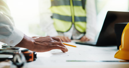 Architecture, meeting and hands of business people with paperwork for urban planning, blueprint and...