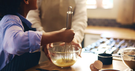 Hands, parent and kid for baking with eggs in bowl for Christmas dessert, cake and meal at home. Closeup, people and teaching or helping for culinary skills, child development and growth in kitchenの写真素材