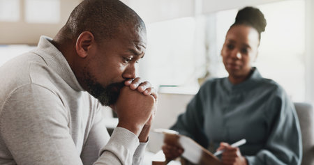 Psychology, therapist and talking in office with man, discussion and advice for mental health. Black...