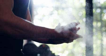 Man, clapping and hands with chalk for fitness, workout preparation or exercise at gym. Closeup, male person or bodybuilder getting ready with powder for weightlifting or training at health clubの写真素材