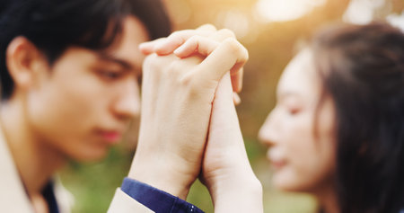 Love, trust and holding hands with Japanese couple in park for romance, bonding and relationship. Support, care and happiness with man and woman in Japan nature for date, commitment and peaceの写真素材