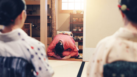 Tea room, hostess and women with ceremony, wellness and traditional kimono for culture. Welcome bow, guests and girls with cultural outfit for matcha drink, process and respect for home hospitalityの写真素材
