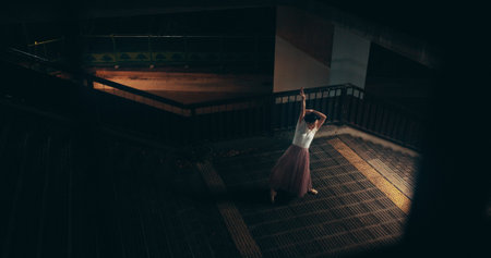Ballet, talent and stairs with Japanese woman in city for balance, theater and elegant performance. Dance, artist and feminine with person or ballerina dancer at night for recital, music or practiceの写真素材