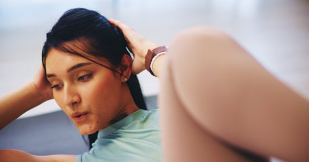 Stretching, crunches and woman with workout routine for calm, strong muscle and mental health. Female person, training and core in home for balance, cardio and fitness as pilates exercise or practiceの写真素材