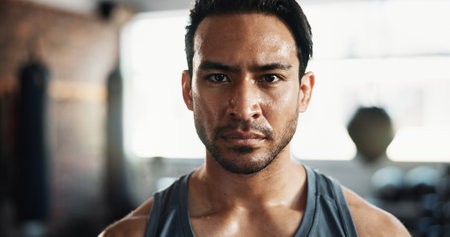 Man, sweat and portrait as serious for exercise, intense workout and wellness with power. Male person, bodybuilder and pride as athlete for health, challenge and training for fitness or sports in gymの写真素材