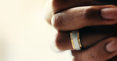 Hands, closeup and ring on finger for marriage, love and romantic commitment with mockup space. Person, wedding band and jewelry accessory with shine of valuable or precious metal symbol for loyaltyの写真素材
