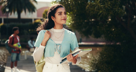 Thinking, university and woman with books, education and student with scholarship, confident and outdoor. Campus, proud and person with knowledge, daydreaming and happy for opportunity at collegeの写真素材