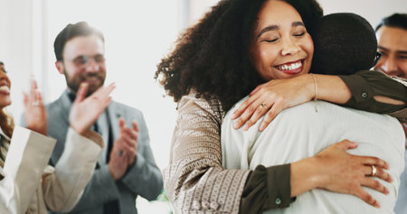 Applause, hugging and success with business people in office for celebration or congratulations of promotion. Embrace, goals and target with employee group clapping in workplace for achievementの写真素材