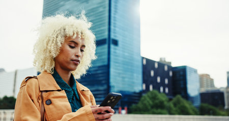 Business, woman and typing with phone outdoor for communication, travel location and transport service. Female person, mobile and contact with texting, networking and reading notification in cityの写真素材