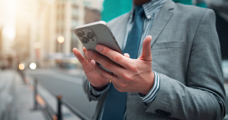 Business, hands and typing with phone in city for mobile chat, location search or online travel booking. Professional, person or smartphone in urban town for checking trip information in Japan streetの写真素材